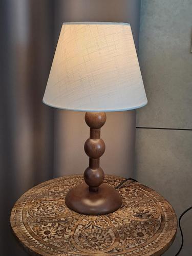 a lamp sitting on top of a table with a lamp at Villa Falesia in Sistiana