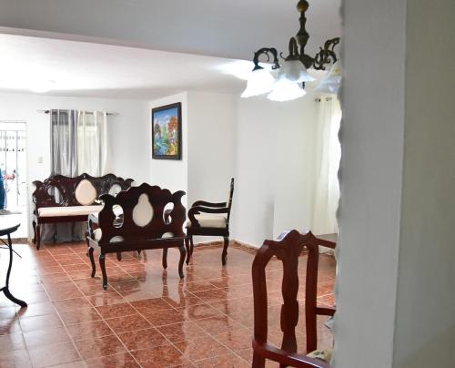 a living room with a couch and a table and chairs at Yolanda's house in Bayaguana