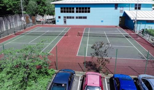 a tennis court with cars parked in a parking lot at Simply Stay in Monaghan