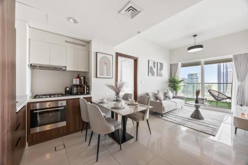 a kitchen and living room with a table and chairs at Burj khalifa and Canal views - Luxury Apartments for Rent in Dubai Business Bay in Dubai