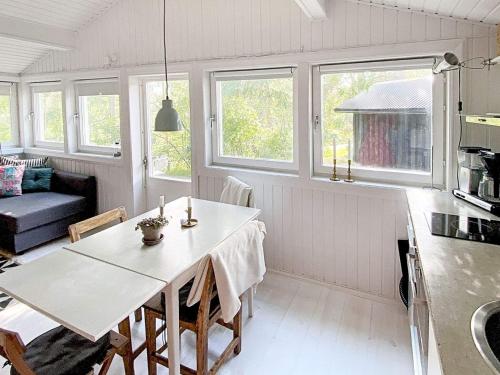 a kitchen and living room with a white table and chairs at Seaside Charm on Okno Island-By Traum in Stora Oknö