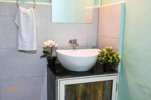 a bathroom with a white sink and a mirror at Nature Nine Farmstay Khopoli in Āmbavna