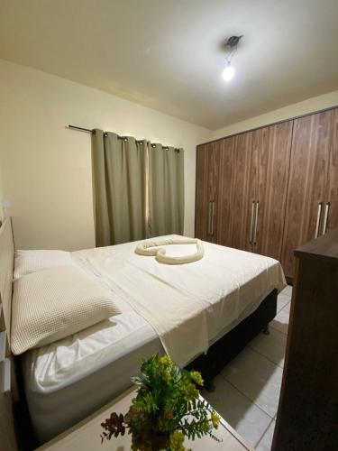 a bedroom with a bed with two pillows on it at Casa verde in Alcobaça