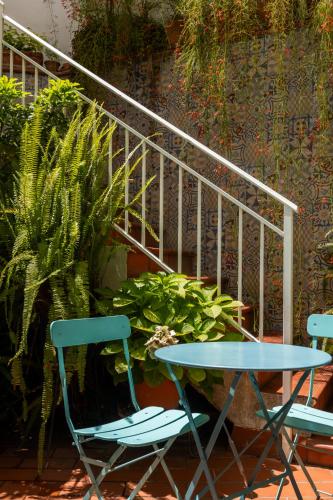 a table and two chairs and a table and a plant at Colectia Hotel Santa Lucía in Seville