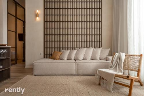 a living room with a couch and a chair at Luxury Apartments And Studios At Sea Side By Rently in Eilat