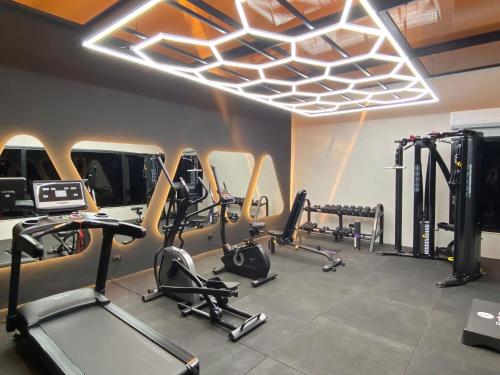 a gym with several treadmills and elliptical machines at Borj Dhiafa in Sfax