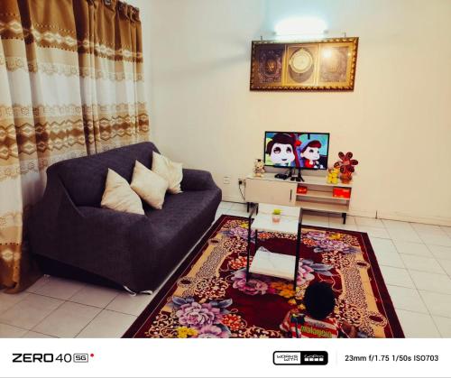 a living room with a couch and a rug at Homestay D'Lapang near KLIA in Sepang