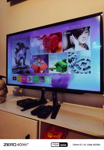 a computer monitor sitting on top of a desk at Homestay D'Lapang near KLIA in Sepang