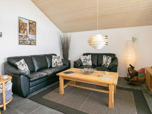 a living room with a couch and a table at 4 star holiday home in Brovst in Brovst