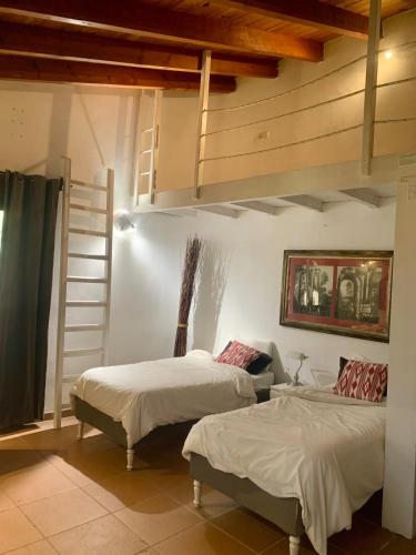 a bedroom with two beds and a ladder at Studio by the sea in Santa Ponsa