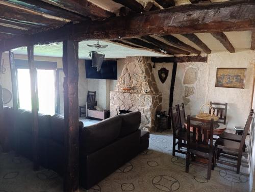 a living room with a couch and a table at La Casona de Alan-Brú in Boceguillas