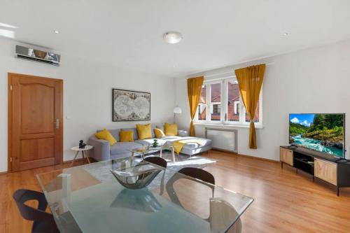 a living room with a glass table and a couch at Exclusive Apartment in Centre in Bratislava