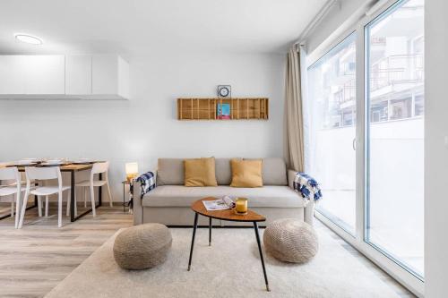 a living room with a couch and a table at Modern and Cozy flat with Balcony in Bratislava