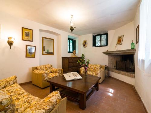 a living room with couches and a table and a fireplace at Spacious Villa Retreat in San Marcello Pistoiese