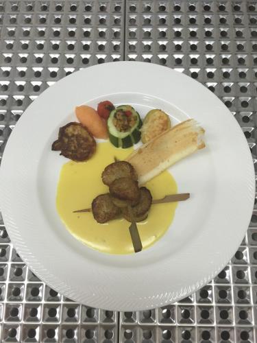 a plate of food with meat and vegetables on it at Auberge Le Meisenberg in Châtenois
