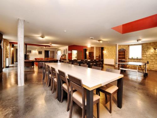 a large dining room with a large table and chairs at Malmedy Luxe Retreat & Spa in Xhoffraix