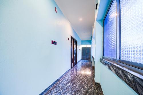 a hallway with a large window in a building at Hotel O MANTRA in Krishnanagar