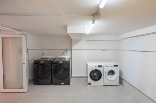 a laundry room with a washer and a washing machine at Palazzo Lucia in Ascea