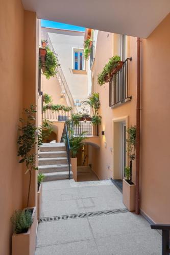 an alley with stairs and potted plants at Palazzo Lucia in Ascea