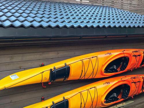 two yellow kayaks sitting on the side of a building at 8 person holiday home in Urangsvåg in Ervik