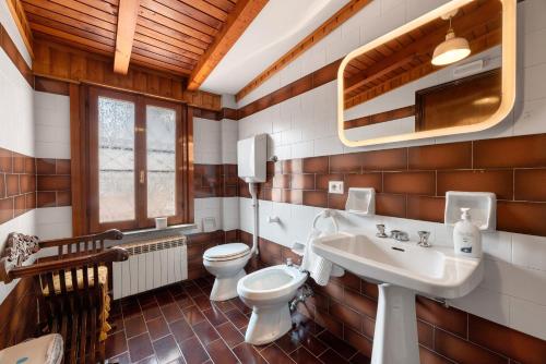 a bathroom with a toilet and a sink at Very Elegant Historic Apartment F2 in Gravedona