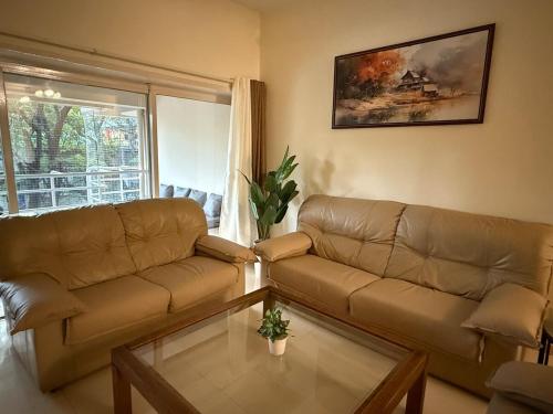 a living room with a couch and a coffee table at Sukh Spacious 2BHK in KP Private 4 Balconies in Pune