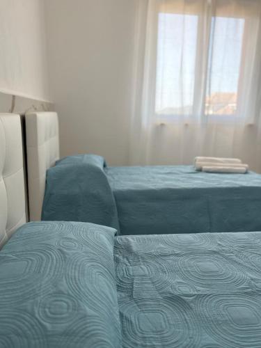 a bedroom with a bed and a bed and a window at Albergo Santa Croce in Giffoni Sei Casali