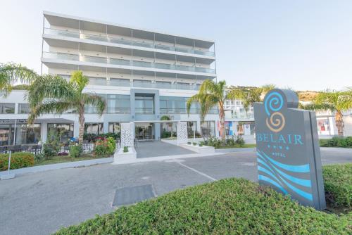 a hotel with a sign in front of a building at Belair Beach Hotel in Ixia