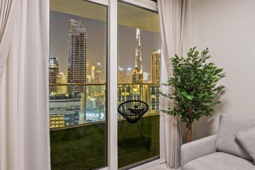 a room with a window with a view of a city at Burj khalifa and Canal views - Luxury Apartments for Rent in Dubai Business Bay in Dubai