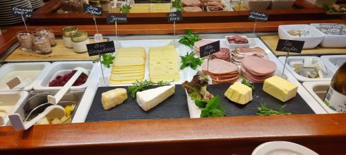 a display case with cheese and meats and cheeses at Hotel Gasthof Edelweiß in Sankt Jakob in Defereggen