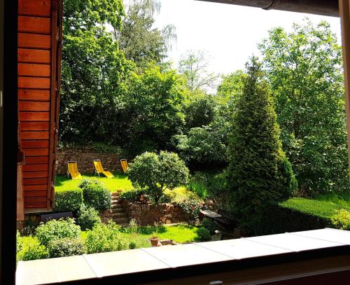 a view of a garden from a window at Hotel Rosenbusch in Großheubach