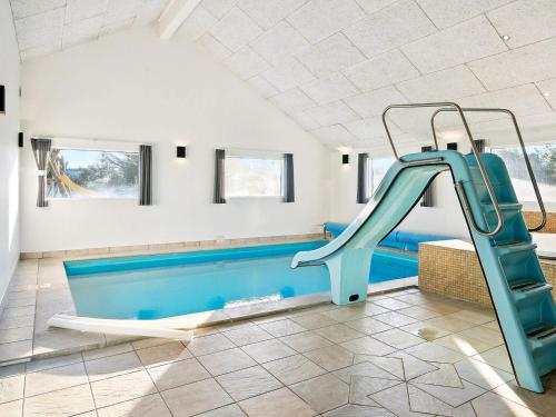 a swimming pool with a blue slide in a house at Luxury Pool Retreat by Sea - By Traum Ferienwohnungen in Harboør