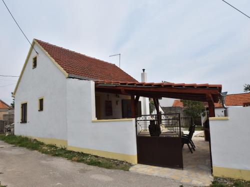 a white house with a wooden pergola on it at Holiday Home in Dalmatia near Krka NP in Lađevci