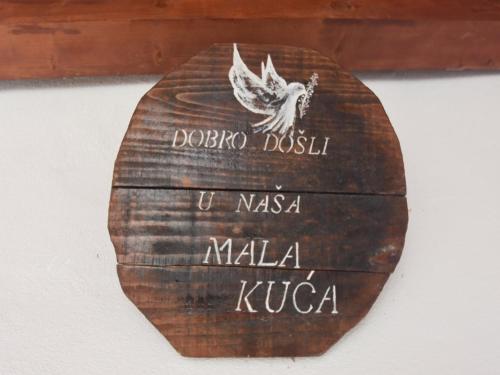 a wooden sign on a wall with the name of a foreign country at Holiday Home in Dalmatia near Krka NP in Lađevci