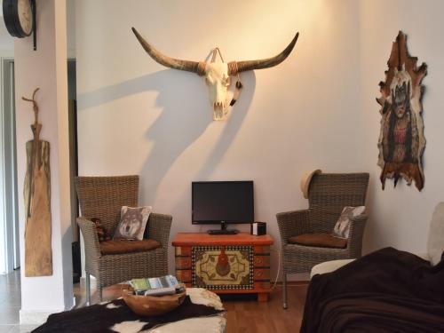 a living room with a bull head on the wall at Holiday Home in Dalmatia near Krka NP in Lađevci