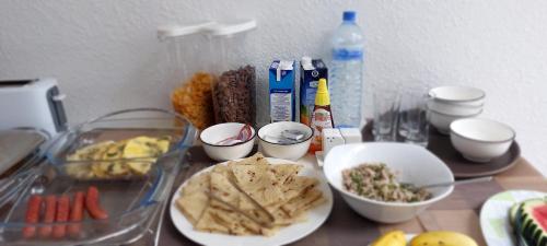 a table topped with plates and bowls of food at Comfy Cool Breeze by eMzaz in Dhiffushi