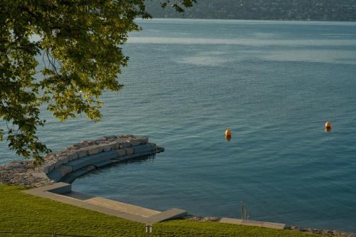 a large body of water with a stone pier at Auberge Port Gitana in Bellevue