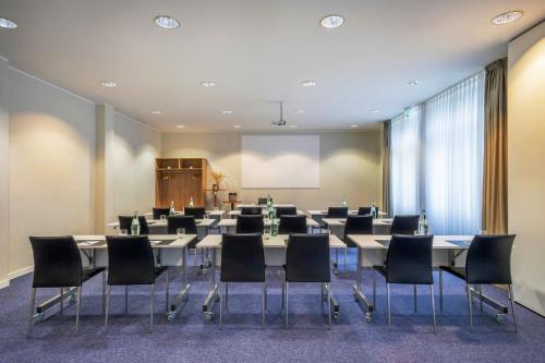 a conference room with a large table and chairs at Hotel Bochum Wattenscheid affiliated by Meliá in Bochum