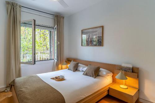 Un dormitorio con una cama grande y una ventana. en 1820 - AB Gaudí Avenue Apartment, en Barcelona