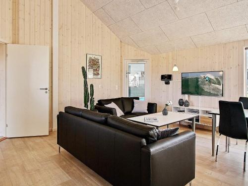 a living room with a couch and a table at 5 star holiday home in Kappeln in Kappeln