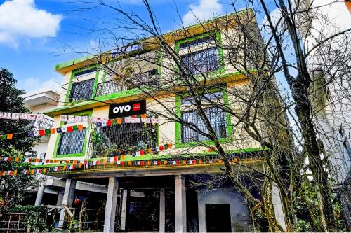 a building with a sign on the side of it at Hotel O Aradhyaa Inn in Dispur