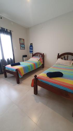 a bedroom with two beds and a window at Hermosa Casa en Los Perales Jujuy in San Salvador de Jujuy