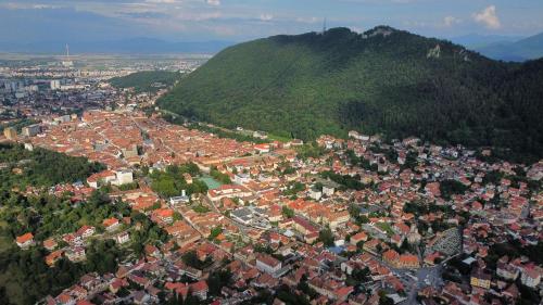 an aerial view of a town in front of a mountain at Seasons-Top of the city in Braşov