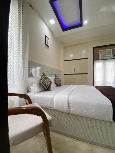 a bedroom with two beds and a tv on the ceiling at Cassava Stay in New Delhi