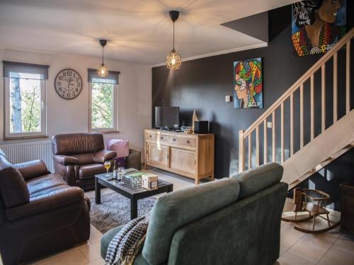 a living room with a couch and a table at Peaceful Durbuy Home & Garden in Durbuy