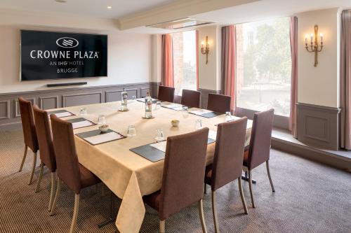 a conference room with a large table and chairs at Crowne Plaza Hotel Brugge by IHG in Bruges