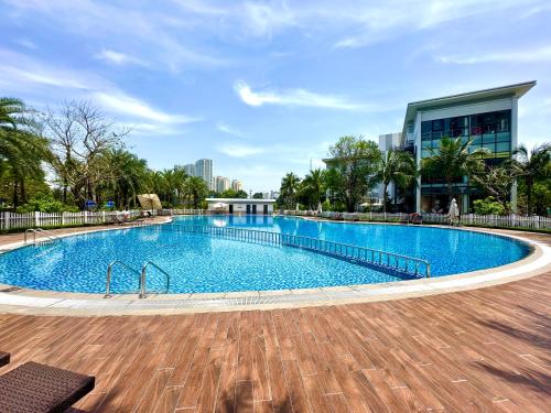 a large swimming pool in front of a building at Delux Apt Studio Near Marriott And Keangnam In City Centre in Kon Rung (1)