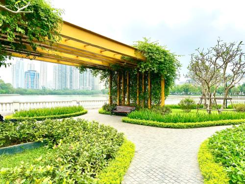 a pavilion with a bench in a park at Delux Apt Studio Near Marriott And Keangnam In City Centre in Kon Rung (1)