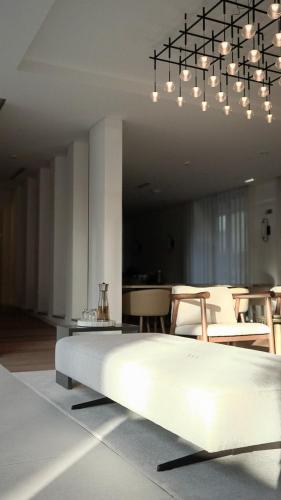 a bedroom with a bed and a dining room at VISEU EXECUTIVE Hotel in Viseu