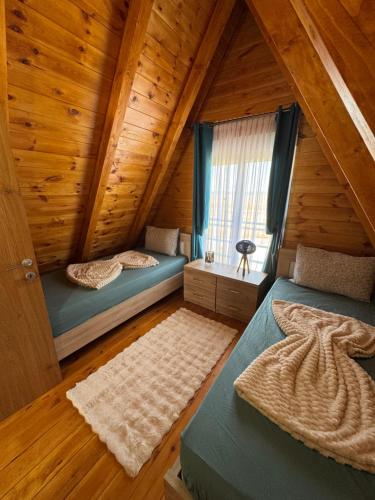a bedroom with two beds in a log cabin at Etno Villa Popovic in Žabljak